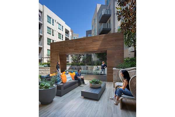 a communal area with couches and plants in an apartment complex